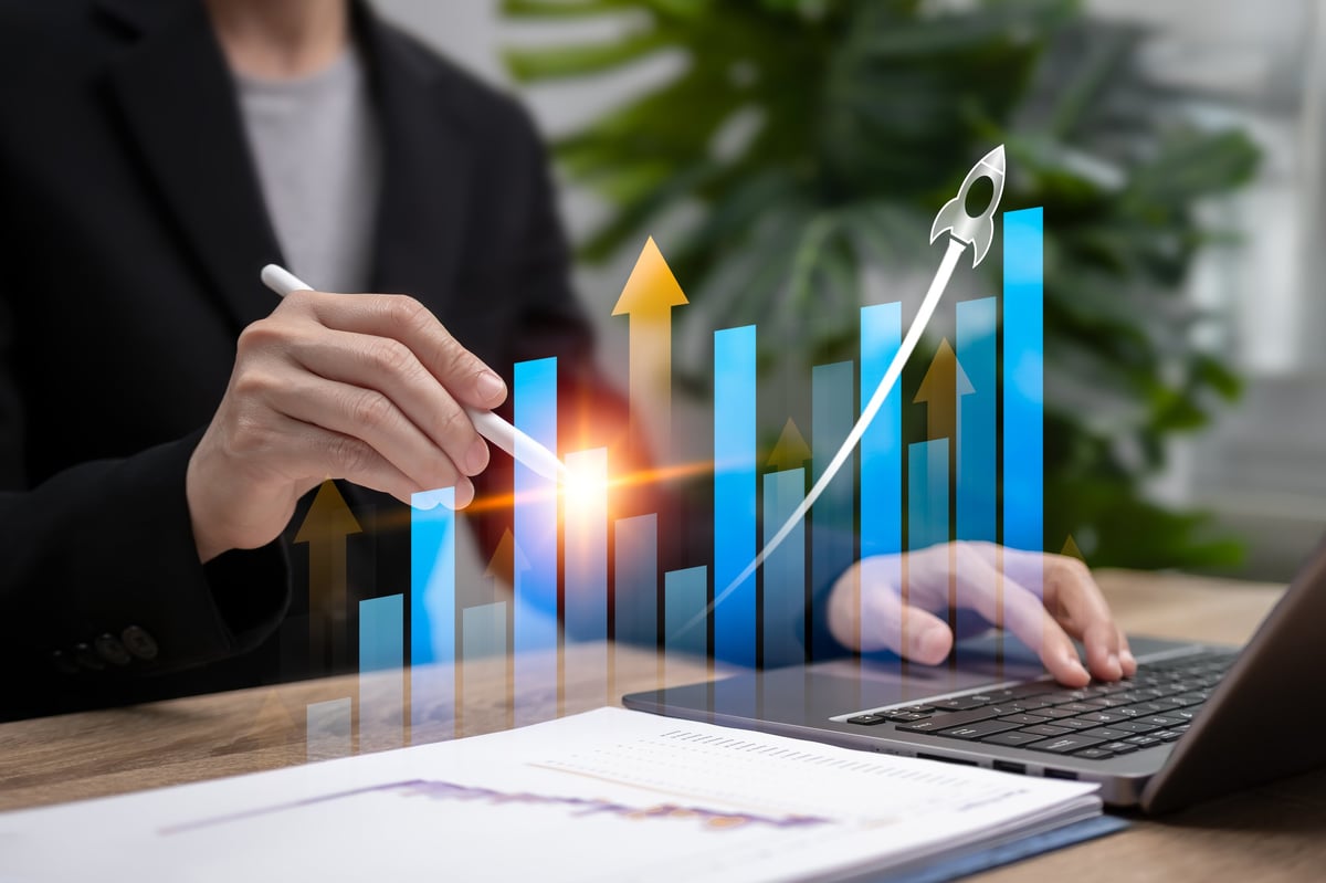 Businesswoman analyzing financial performance with a bar chart showing growth