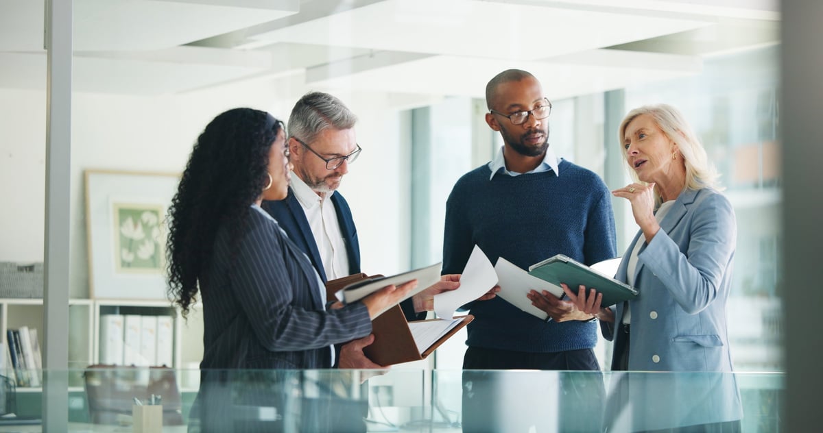 Business colleagues in a meeting reviewing financial documents and reports